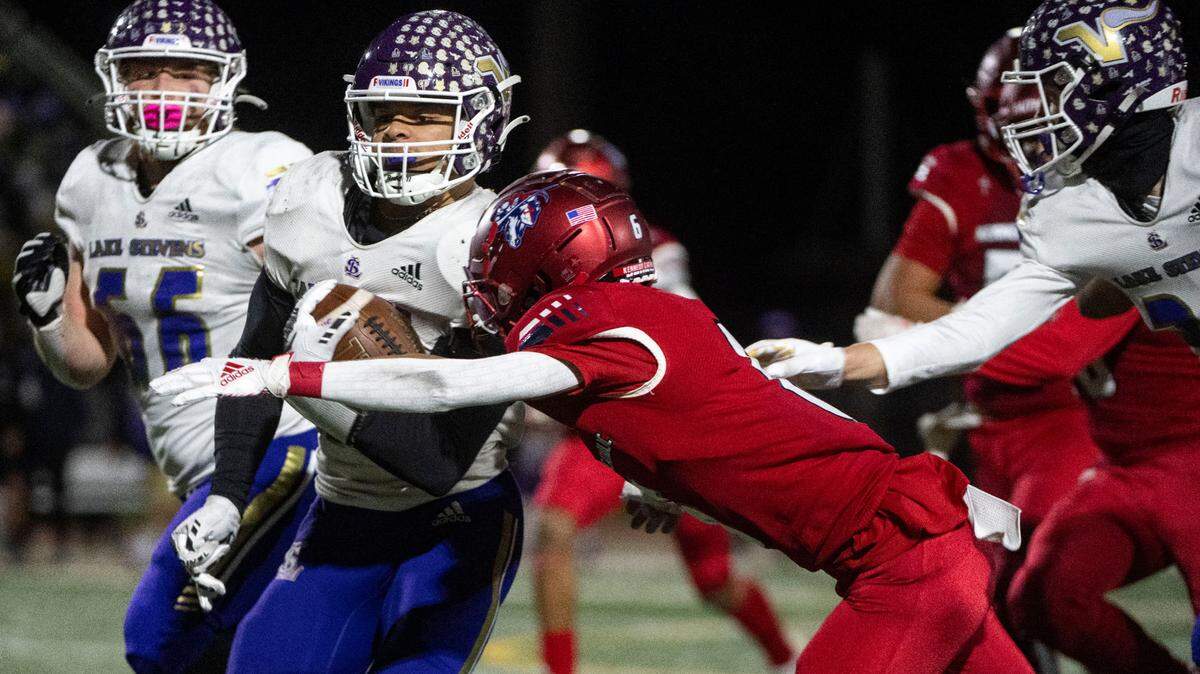 Lake Stevens running back Jayden Limar runs past Kennedy Catholic’s Isaac Syph during the second quarter of the Class 4A state championship game on Saturday, Dec. 3, 2022, at Mount Tahoma High School in Tacoma, Wash.