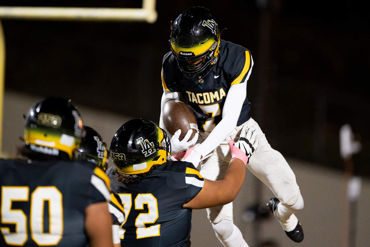 Lincoln’s Messiah Ellick (7) celebrates his touchdown with teammates during the first half of the game against Bellarmine Prep at Lincoln High School, on Friday, Oct. 18, 2024, in Tacoma, Wash.