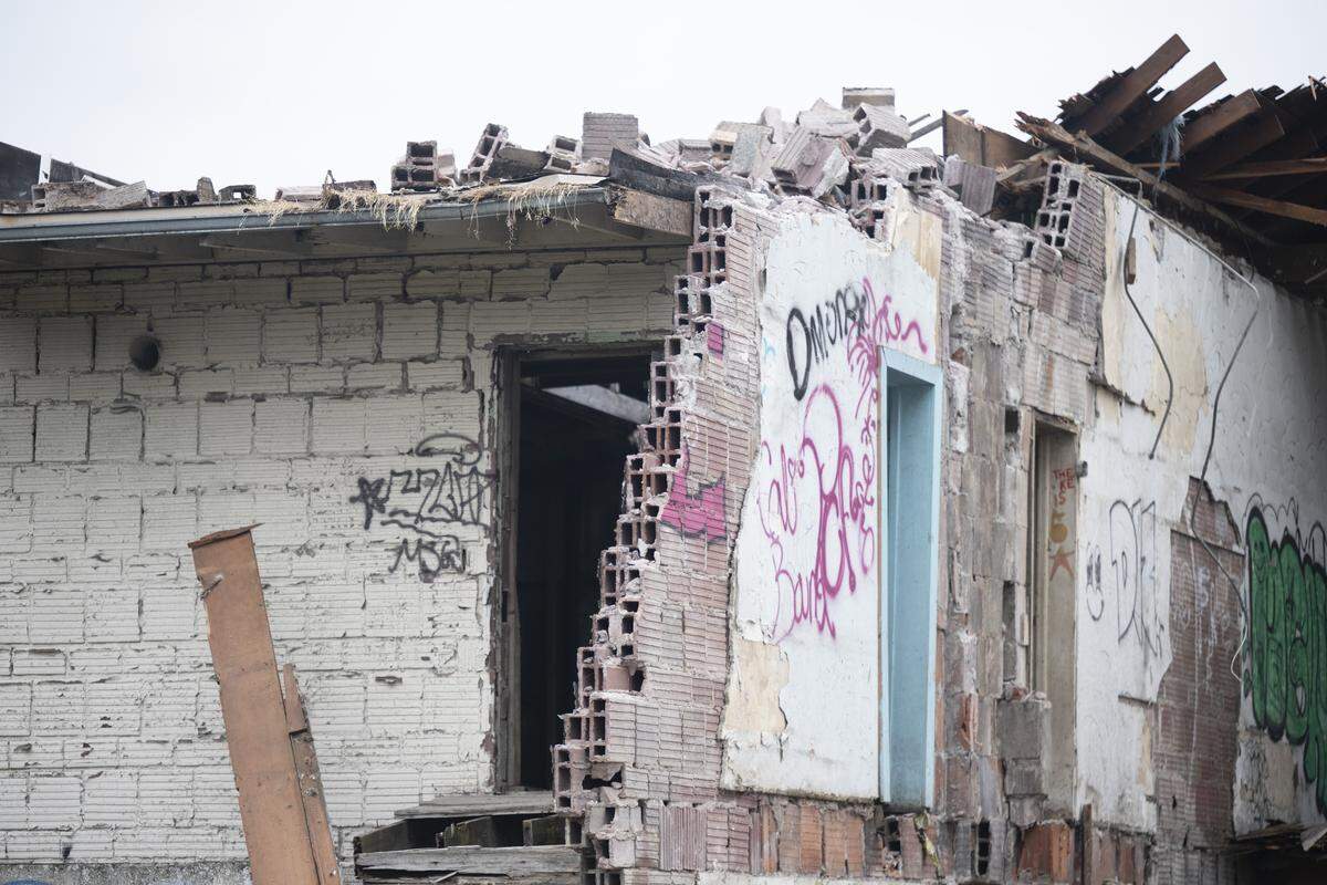 The historic Alderton School building stands halfway demolished on Tuesday, May 19, 2026, after an order was issued to stop the demolition.