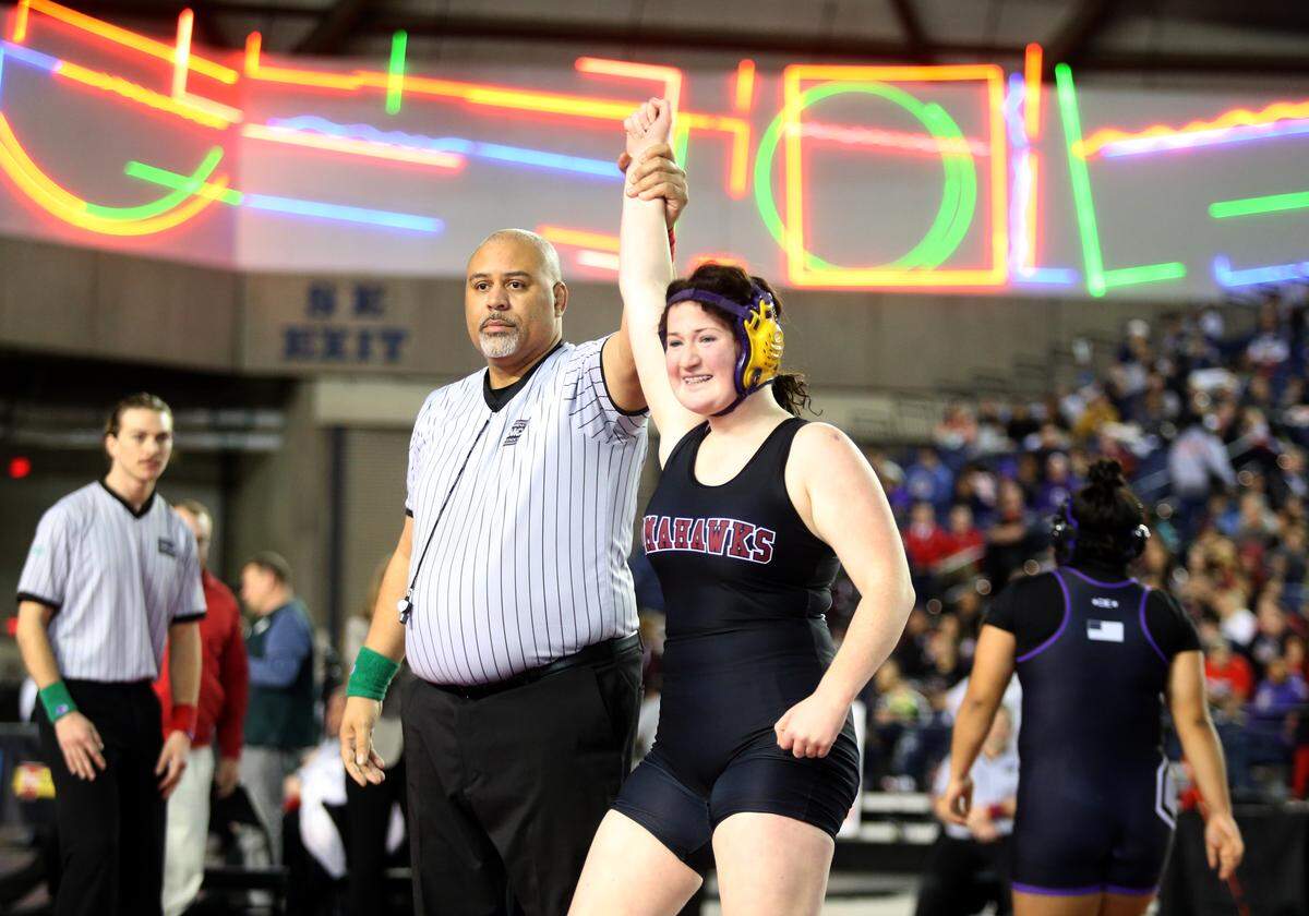 Marysville-Pilchuck’s Alivia White is all smiles as her arm is raised after pinning Connell’s Rosa Saucedo-Ramirez in their championship match at Mat Classic XXXII in the Tacoma Dome on Saturday, Feb. 22, 2020 in Tacoma, Wash. (Andy Bronson / The Herald)
