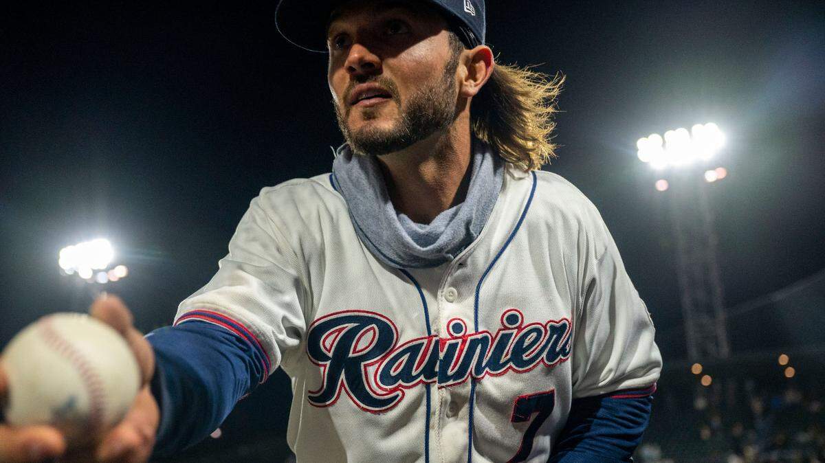Tacoma outfielder Forrest Wall (7) tosses a ball to a young fan after the Rainiers beat the Salt Lake Bees, 4-2, in the season opener at Cheney Stadium in Tacoma on April 5, 2022.