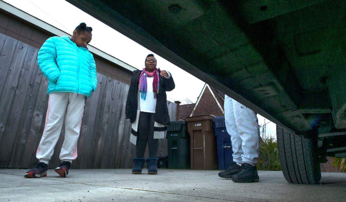 Danay Conley (center) with her daughter, Lylah, 10, and son, John, outside their home in Tacoma, Washington, on Tuesday, Feb. 22, 2022.