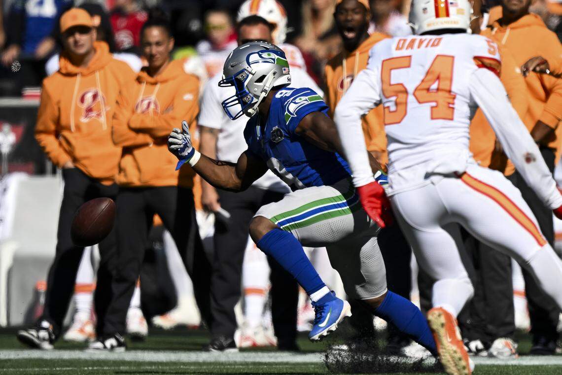 Seattle Seahawks running back Kenneth Walker III (9) fumbles a trick play with quarterback Jalen Milroe (6) during the second quarter of the game at Lumen Field, on Sunday, Oct. 5, 2025, in Seattle.