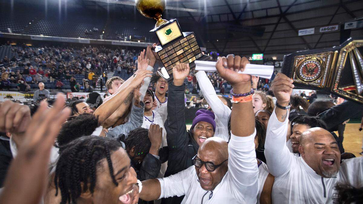 The Garfield Bulldog celebrate following their victory over the O’Dea Fighting Irish, 69-50, in the 3A boys state title game at the WIAA state basketball tournament in the Tacoma Dome in Tacoma, Washington, on Saturday, March 4, 2023.