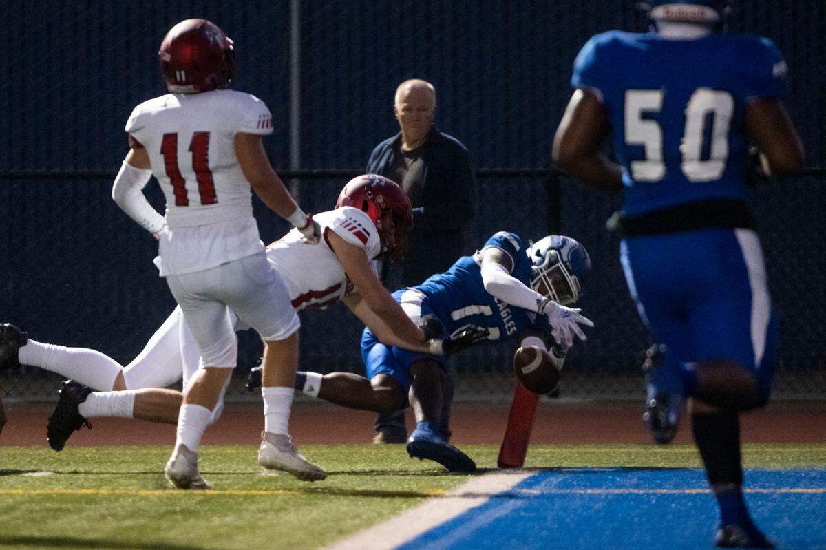 Federal Way’s Rahshawn Clark dives for the pylon as he gets tackled by Kennedy Catholic Dante Saldino during the first quarter of a 4A NPSL game on Friday, Sept. 30, 2022, at Federal Way Memorial Field in Federal Way, Wash. Clark was called out of bounds at the one-yard line.