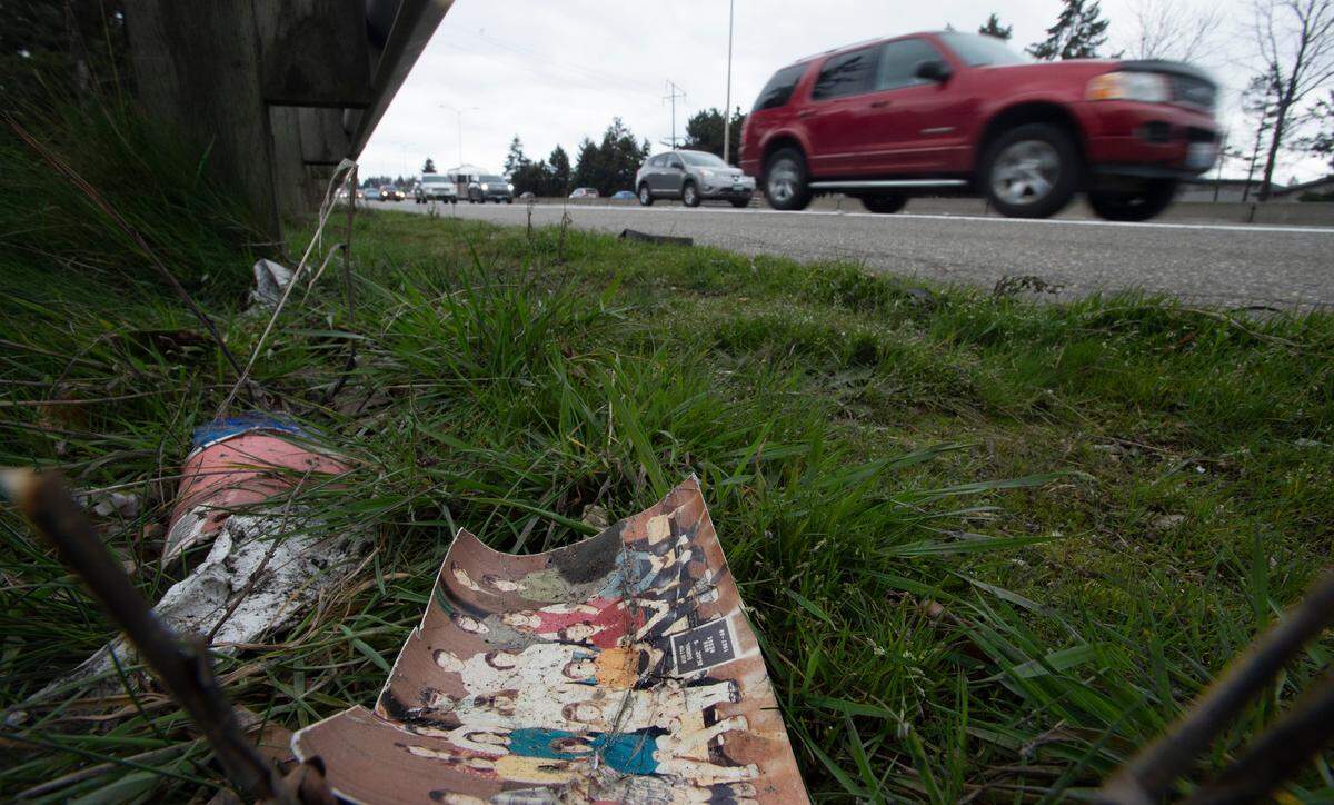 A 1967 fifth-grade class photo from Ruston School lies alongside other trash littering Interstate 5 through Tacoma, Washington, on Wednesday, Feb. 17, 2021.
