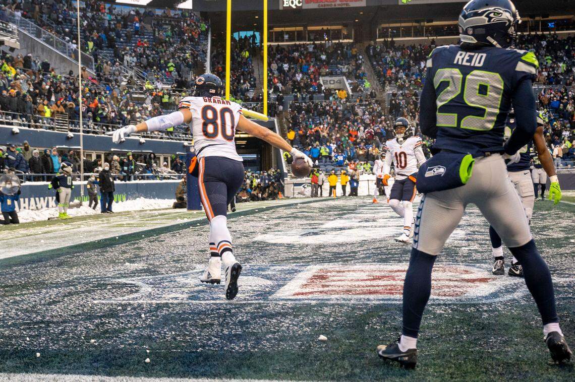 Chicago Bears tight end Jimmy Graham (80) celebrates after catching a touchdown as Seattle Seahawks cornerback John Reid (29) looks on during the fourth quarter of an NFL game on Sunday afternoon at Lumen Field in Seattle.
