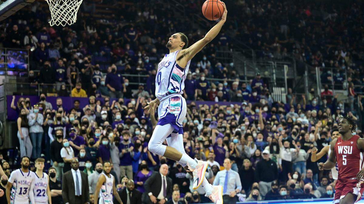 Washington forward Emmitt Matthews Jr. (0) dunks the ball on a fast break as Washington State guard TJ Bamba (5) watches late in the second half of a Pac-12 game on Saturday, Feb. 26, 2022, in Seattle. Washington beat Washington State, 78-70.