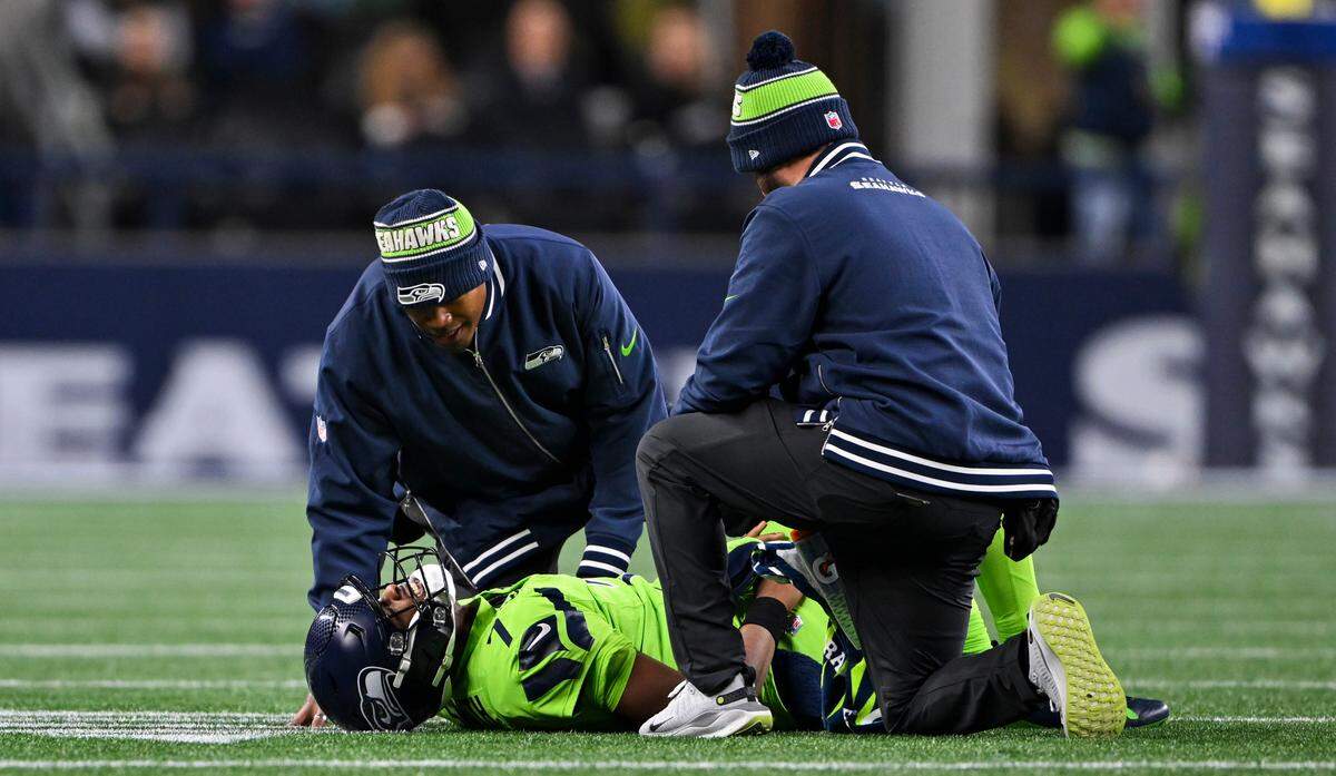 Seattle Seahawks quarterback Geno Smith (7) lays on the turf after a play against Green Bay Packers during the third quarter of the game at Lumen Field, on Sunday, Dec. 15, 2024, in Seattle, Wash.