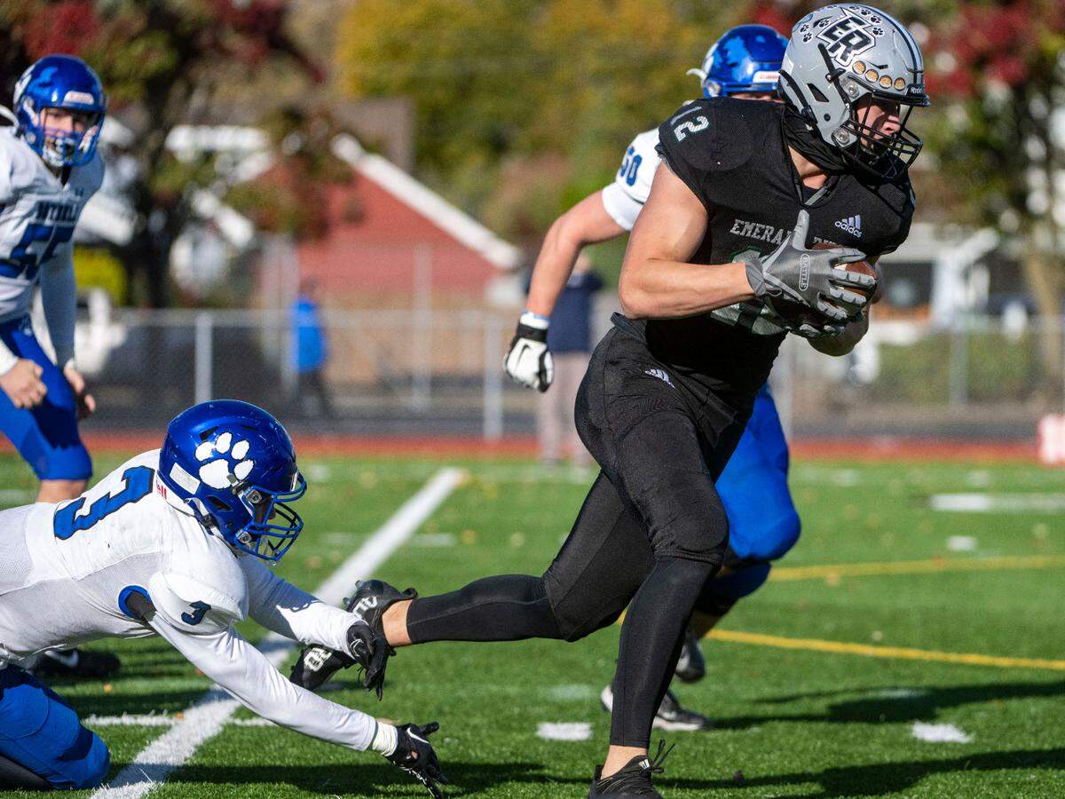 Emerald Ridge’s Jacob Lane skips away from a tackle attempt by Bothell punter Tyson Hoke as he returns a punt block for a touchdown during the first quarter of a Week 10 4A playoff game on Saturday, Nov. 5, 2022, at Sparks Stadium in Puyallup, Wash.