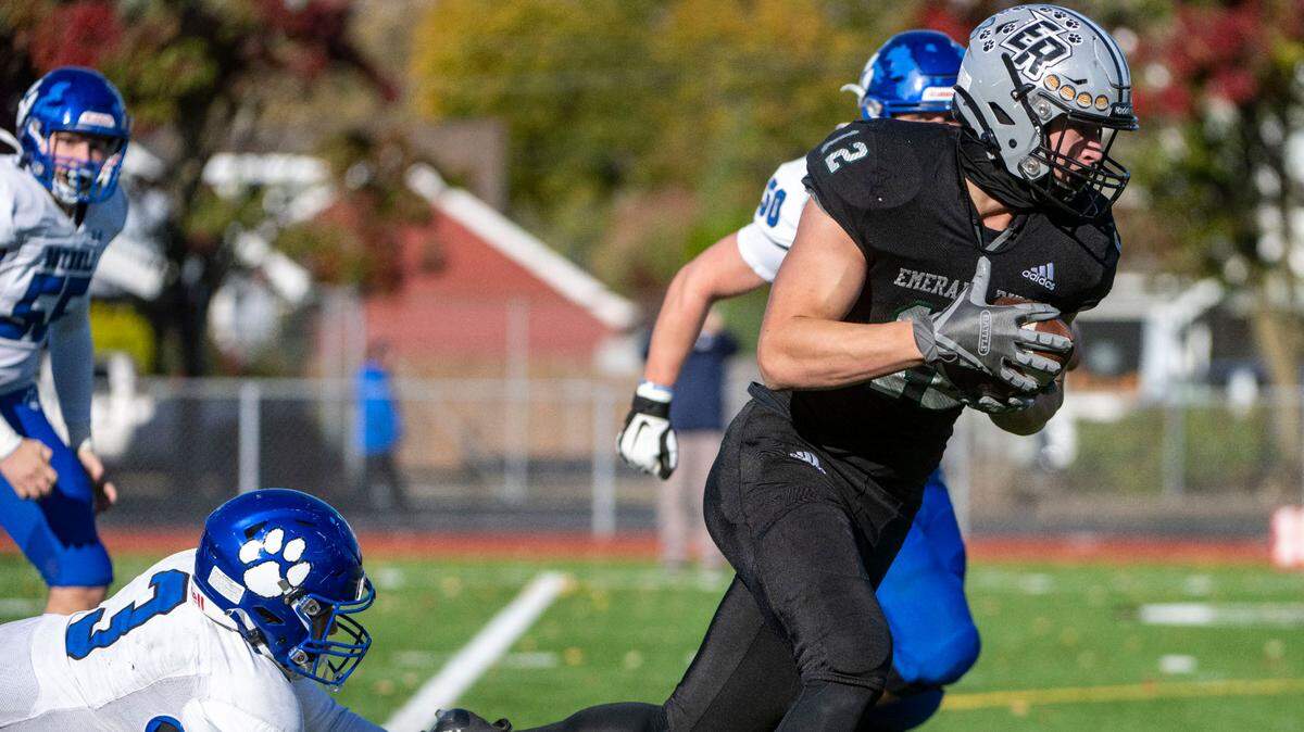 Emerald Ridge’s Jacob Lane skips away from a tackle attempt by Bothell punter Tyson Hoke as he returns a punt block for a touchdown during the first quarter of a Week 10 4A playoff game on Saturday, Nov. 5, 2022, at Sparks Stadium in Puyallup, Wash.