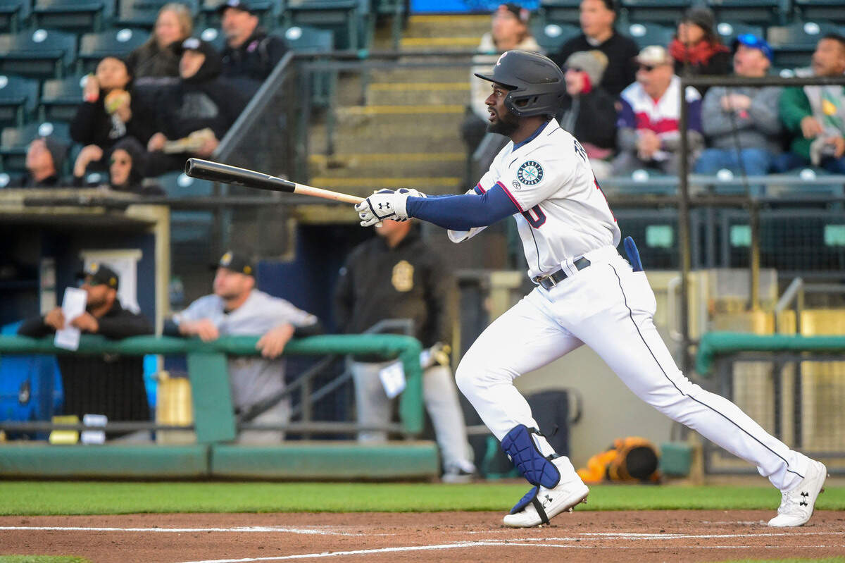 Tacoma Rainiers outfielder Taylor Trammell (10) watches as his sharply hit fly ball bounces off the wall and scores Forrest Wall during the first inning of the season opener against the Salt Lake Bees at Cheney Stadium in Tacoma, Wash., Tuesday on April 5, 2022.