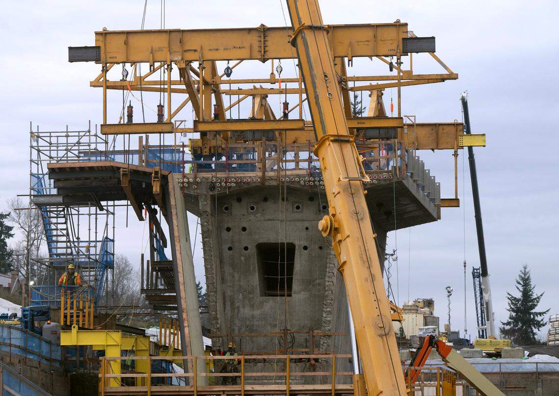 Officials are excited to see “The Traveler” ready to begin laying decking at the Federal Way Link Extension bridge construction in Federal Way, Washington, on Monday, Dec. 18, 2023.