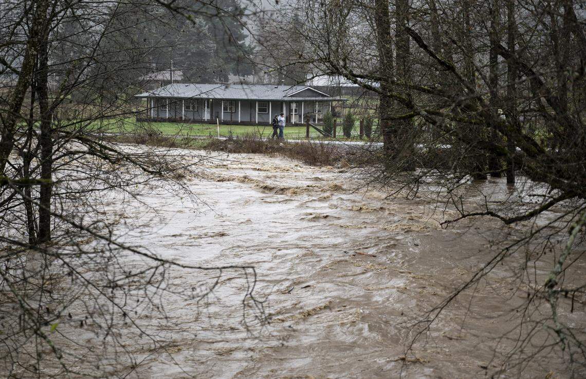 The South Prairie Creek flows and surges as an evacuation warning is in place for homes near the South Prairie Creek, on Thursday, Dec. 11, 2025, in South Prairie, Wash.