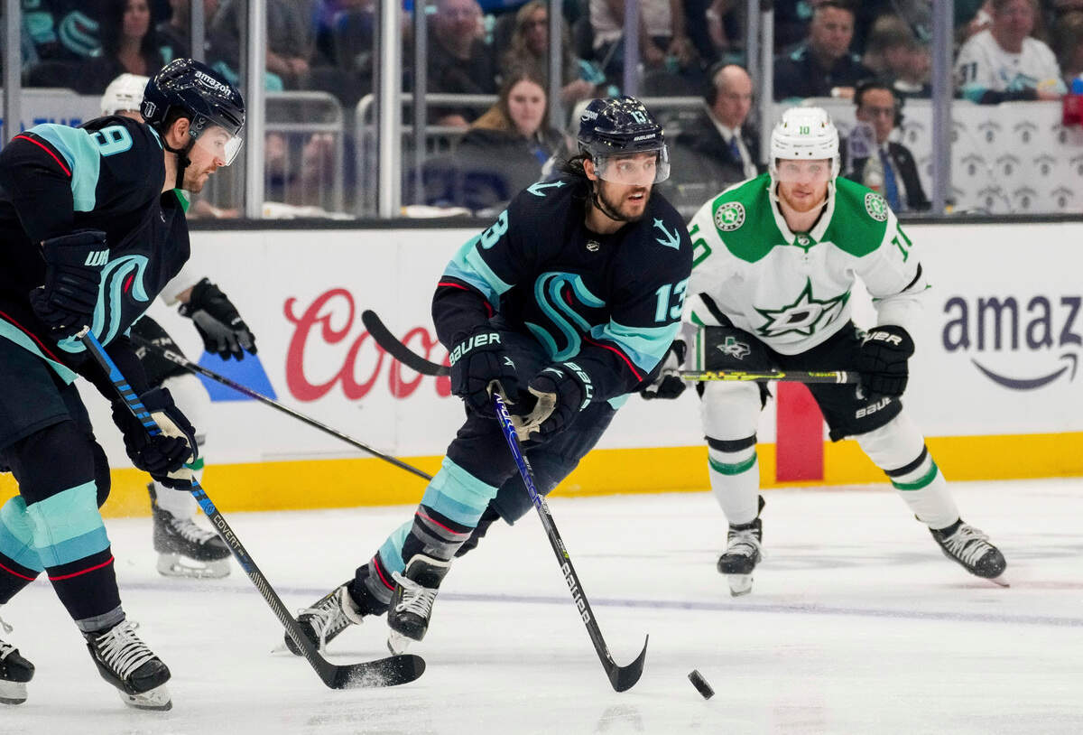 Seattle Kraken left wing Brandon Tanev (13) moves the puck as Dallas Stars center Ty Dellandrea (10) watches during the second period of Game 6 of an NHL hockey Stanley Cup second-round playoff series Saturday, May 13, 2023, in Seattle. (AP Photo/Lindsey Wasson)