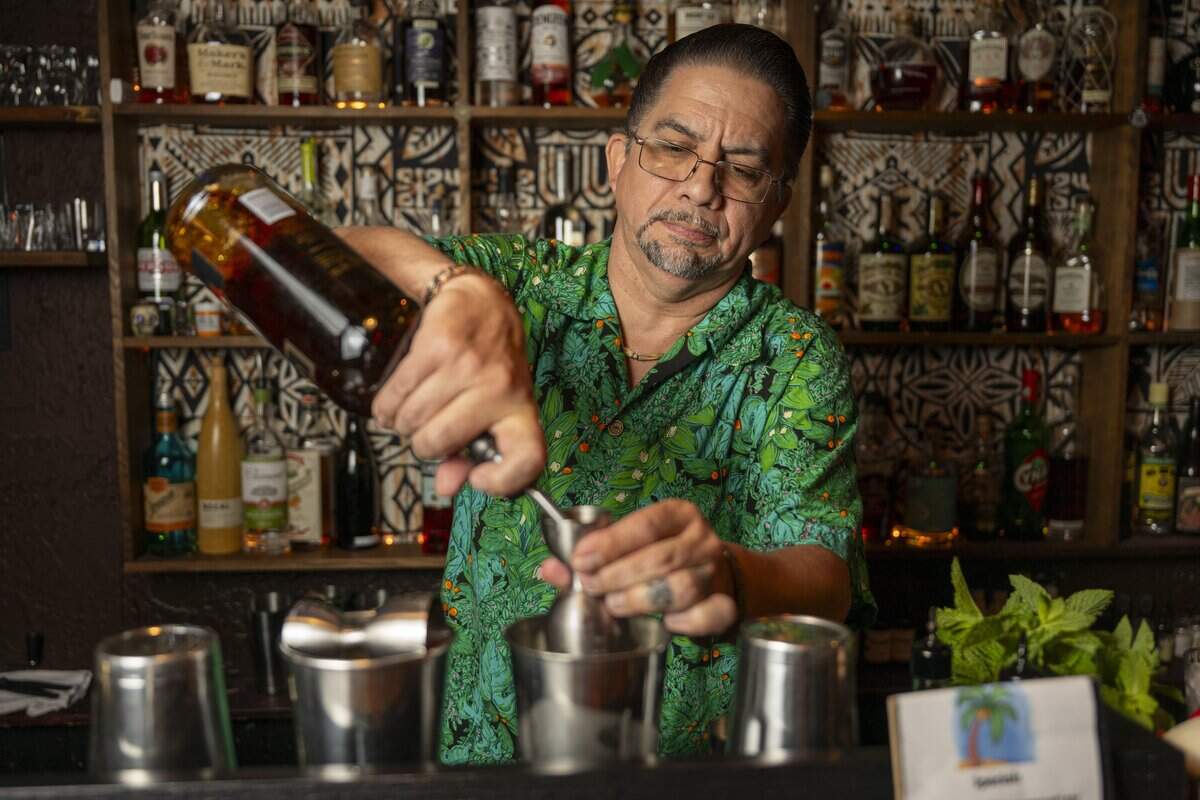 Bartender Rob Canavan prepares cocktails behind the bar at Da Tiki Hut on Thursday, July 9, 2026, in Tacoma, Wash.