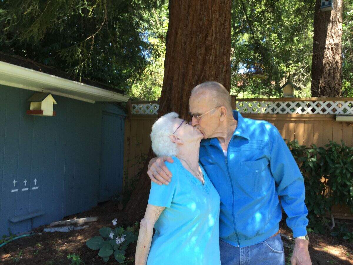 Betty Asplund, left, kisses her husband of 75 years Eric Asplund. The two Gig Harbor residents will celebrate their anniversary on July 31.