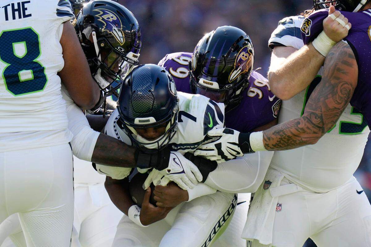 Seattle Seahawks quarterback Geno Smith (7) is sacked by Baltimore Ravens linebacker Odafe Oweh (99) during the first half of an NFL football game, Sunday, Nov. 5, 2023, in Baltimore. (AP Photo/Alex Brandon)