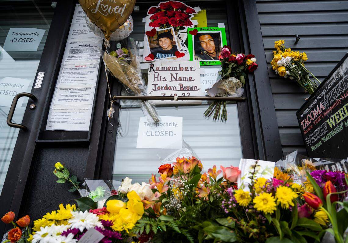 A memorial for Jordan Brown sits outside of Wolrd of Weed on the 3200 block of East Portland Avenue in Tacoma, Wash. on Saturday, March 26, 2022. Brown was shot and killed in an armed robbery while working at the shop on March 19, 2022. 