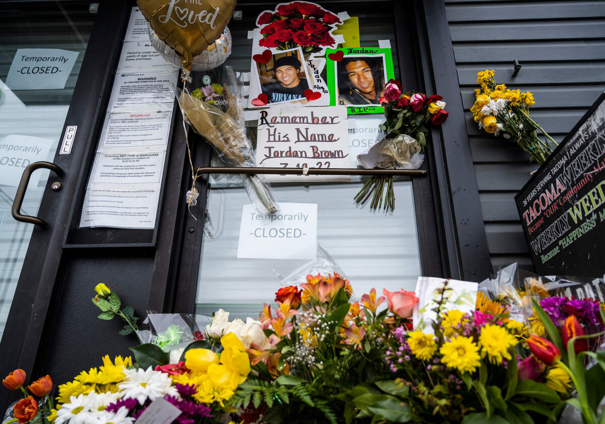 A memorial for Jordan Brown sits outside of Wolrd of Weed on the 3200 block of East Portland Avenue in Tacoma on Saturday, March 26, 2022. Brown was shot and killed in an armed robbery while working at the shop on March 19, 2022.