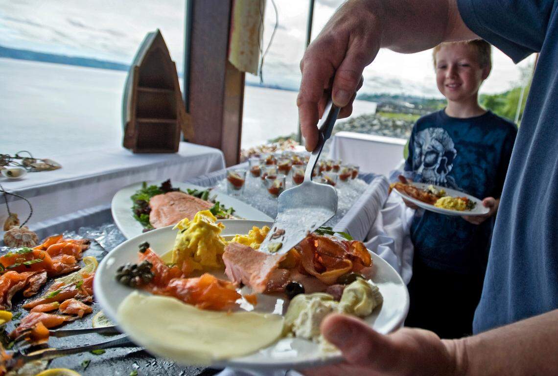 Jack Livingston’s father dishes up some salmon at the Sunday brunch buffet at The Lobster Shop on Tacoma’s waterfront. June 3, 2012 Peter Haley / Staff photographer