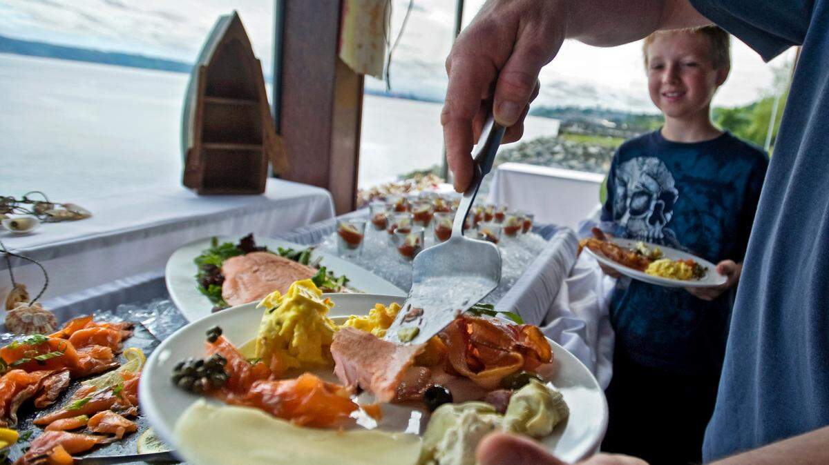 Jack Livingston’s father dishes up some salmon at the Sunday brunch buffet at The Lobster Shop on Tacoma’s waterfront in June 2012.