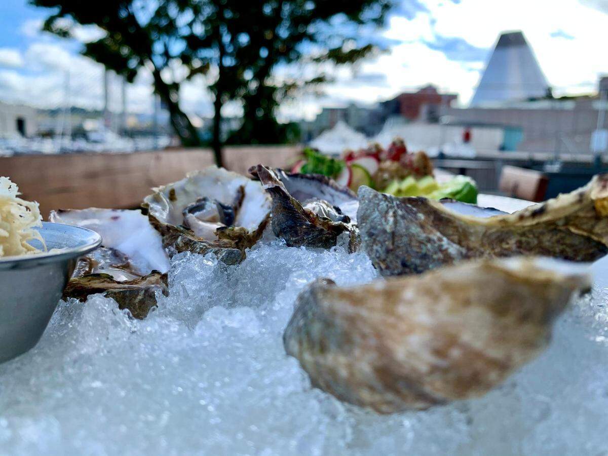 The Social Bar & Grill, located on Tacoma’s Thea Foss Waterway downtown, was built with outdoor seating in mind. The built-in patio features picnic-style cement tables equipped with propane heaters.
