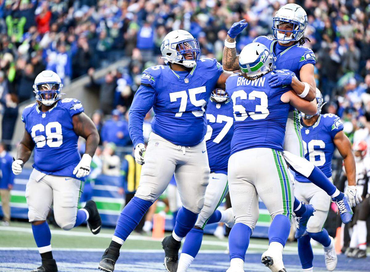 Seattle Seahawks wide receiver Jaxon Smith-Njigba (11) celebrates a touchdown with teammates during the fourth quarter of the game against the Cleveland Browns at Lumen Field, Sunday, Oct. 29, 2023, in Seattle, Wash.