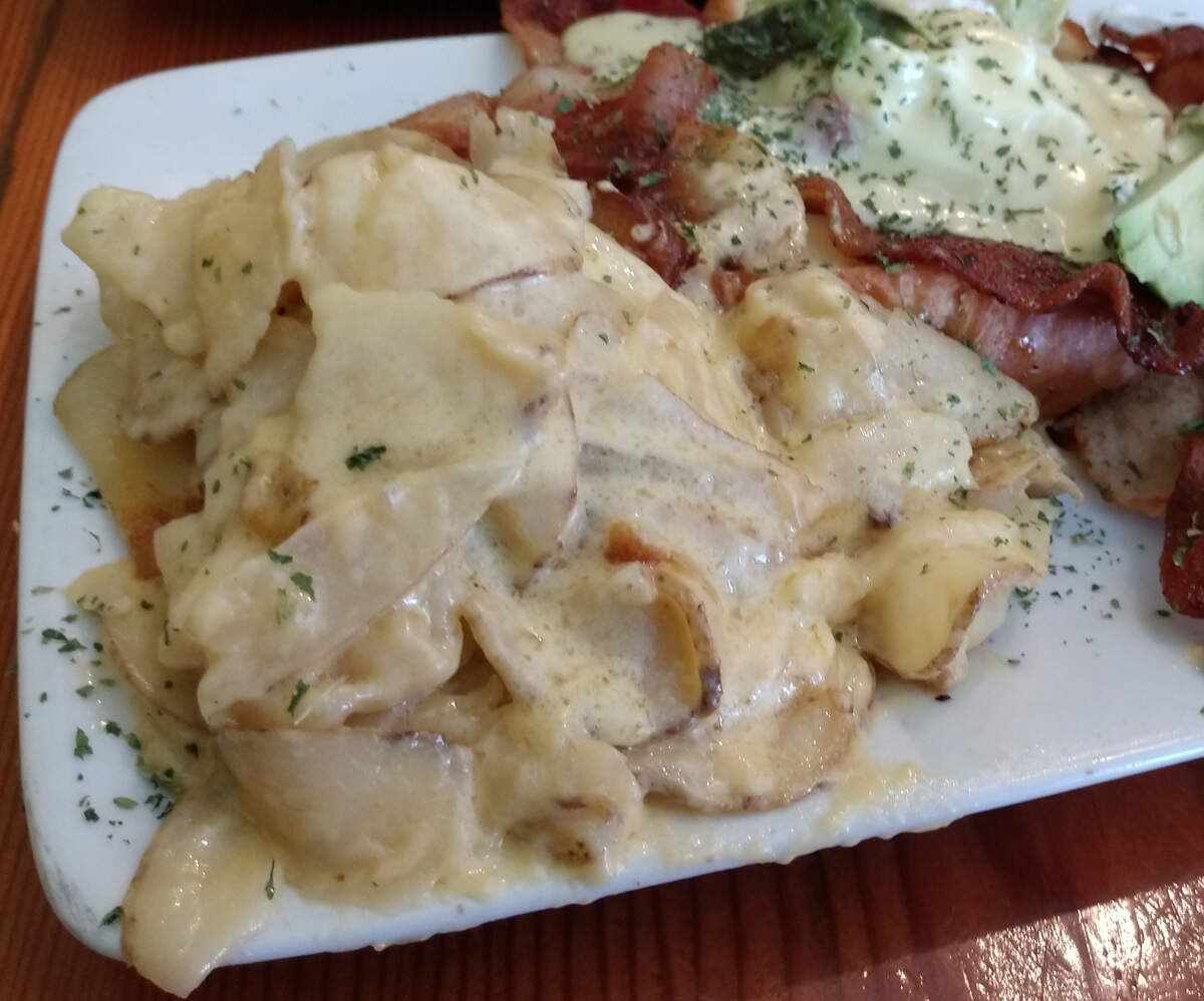 Stink Spuds come with a sauce that’s like a cheese lava that oozes on the plate at Stink Cheese + Meat.