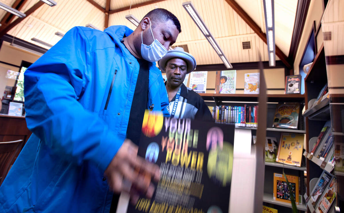 James Johnson (left) and Marcus Taylor check the ballot box pass at the Charlotte Mottet Branch Library in eastside Tacoma, Washington, on Tuesday, May 10, 2022.