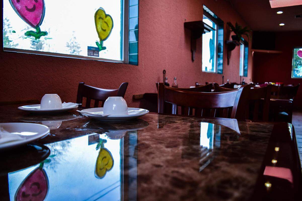 A table is set for tea in the front dining room of Harbor City Tacoma, now open at 4816 S. Pacific Ave.