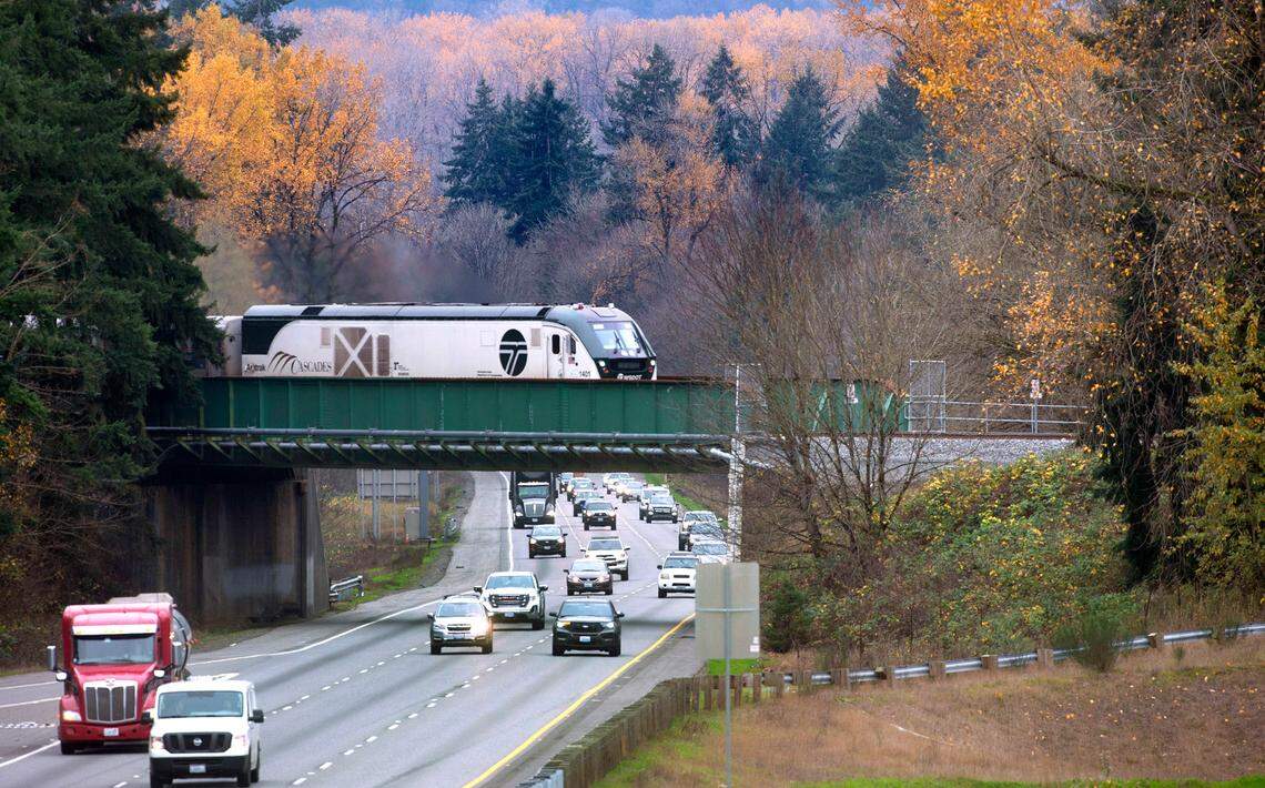 The northbound Amtrak Cascades train rolls across the Interstate 5 overpass in DuPont, Washington, on Thursday, Nov. 18, 2021.