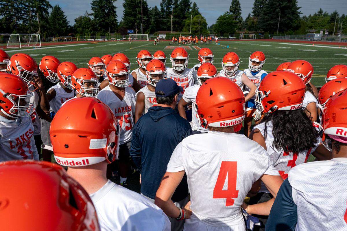 Lakes head coach Dave Miller addresses the team after a drill during practice on Friday, Aug. 18, 2023, at Lakes High School in Lakewood, Wash.