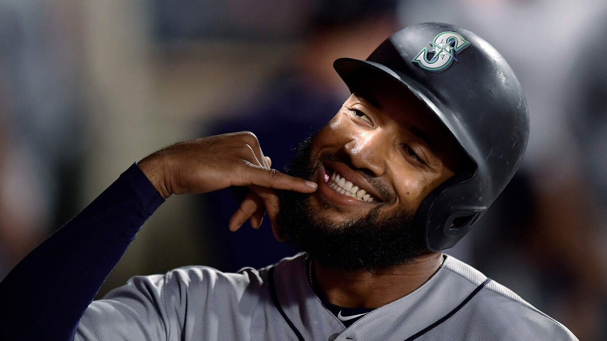 Seattle Mariners’ Domingo Santana gestures in the dugout after hitting a solo home run during the seventh inning of the team’s baseball game against the Los Angeles Angels Friday, June 7, 2019, in Anaheim, Calif.