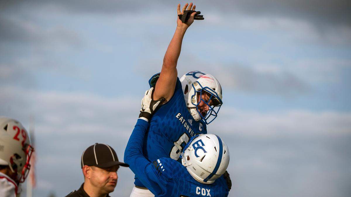 Eatonville’s Blain Hanly is lifted up by Kyle Cox after Hanly returned an interception for a touchdown during the fourth quarter of a State 1A quarterfinal game against Riverside on Saturday afternoon at Art Crate Field in Spanaway.
