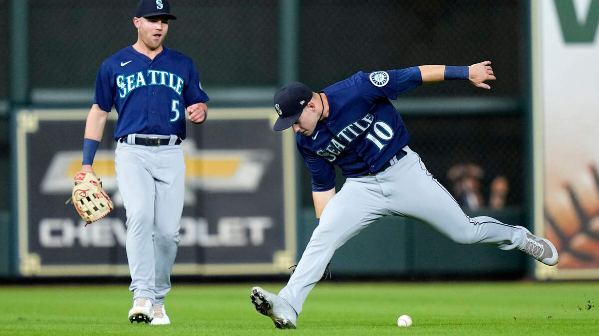 Seattle Mariners center fielder Jarred Kelenic (10) tries to field an RBI single by Houston Astros’ Jake Meyers as left fielder Jake Bauers (5) watches during the fifth inning of a baseball game Monday, Sept. 6, 2021, in Houston. (AP Photo/David J. Phillip)