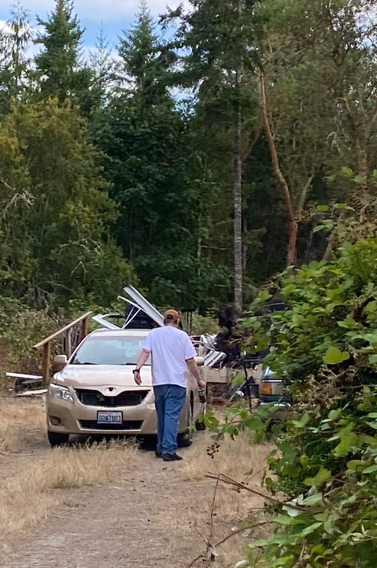 Leeland “Butch” Smith walking on his property after the fire.