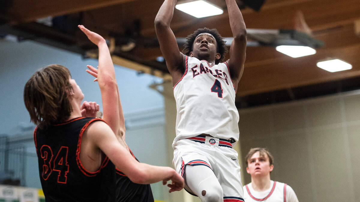 Life Christian’s guard Bradley Swillie (4) jumps to shoot the ball as Zillah’s forward Luke Navarre (34) defends during the high school boys 1A basketball state tournament regional round game at Foss High School in Tacoma, Wash. on Saturday, Feb. 26, 2022.