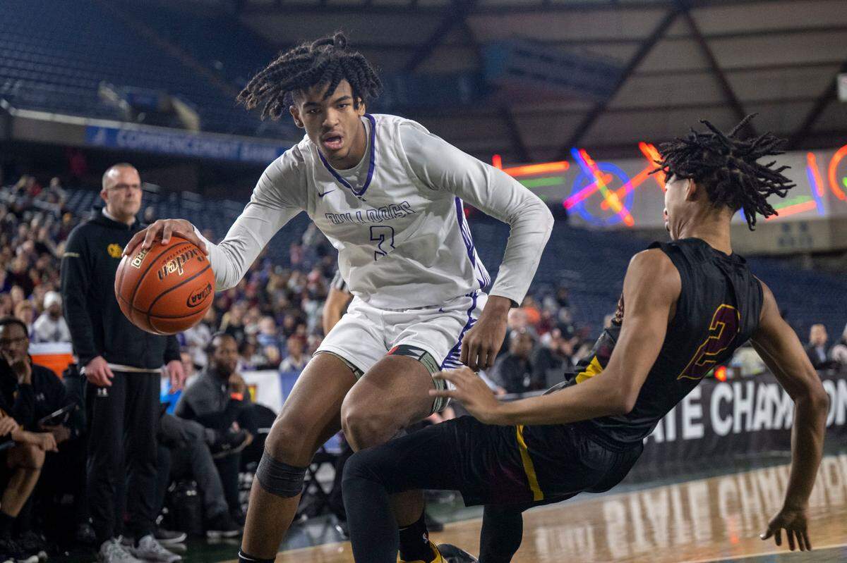 O’Dea guard Mason Williams (2) draws a charge on Garfield forward Jaylin Stewart (3) as he drives toward the baseline during the first quarter of the Class 3A championship game on Saturday, March 4, 2023, in Tacoma, Wash.