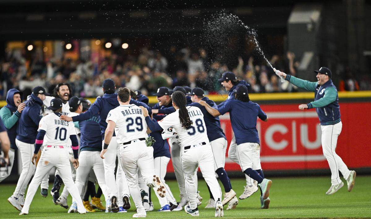 The Seattle Mariners celebrate their 3-2 win in Game 5 of the AL Division Series against the Detroit Tigers at T-Mobile Park, on Friday, Oct. 10, 2025, in Seattle.