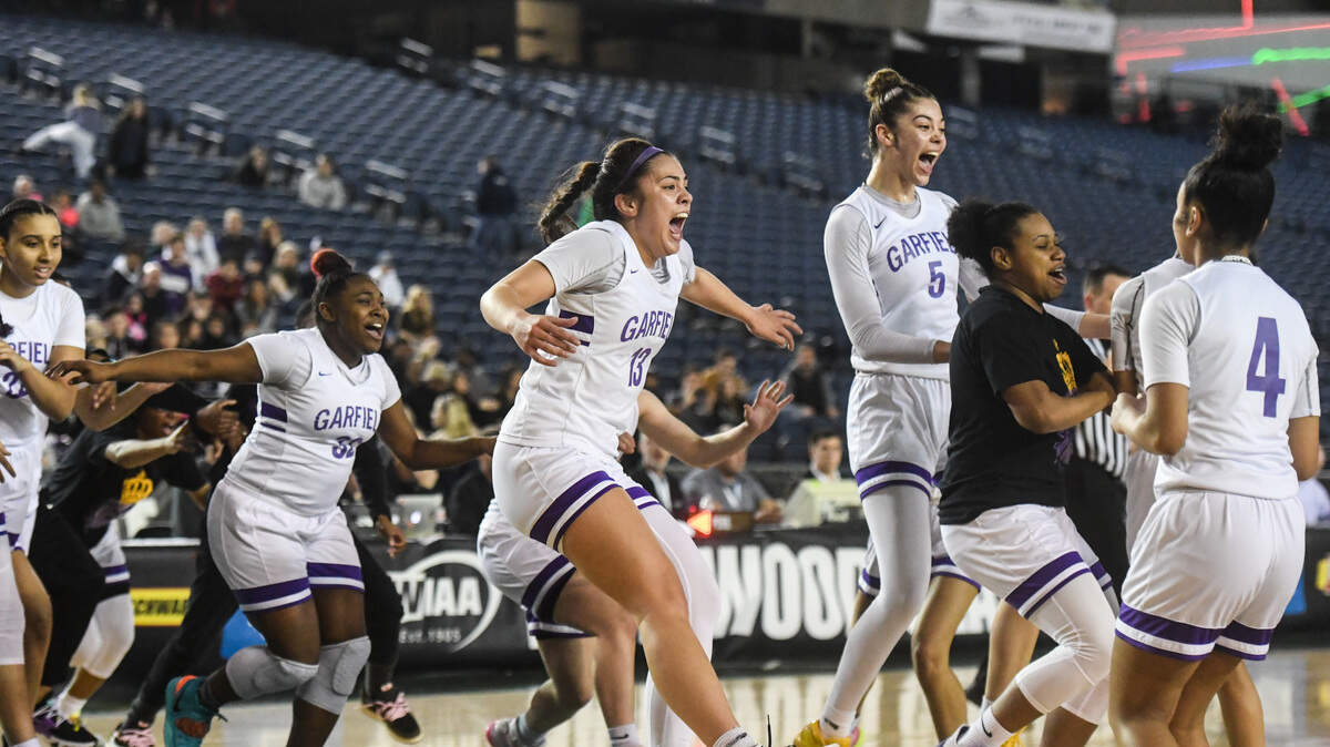 Garfield players celebrate their state title win. Garfield played Lake Washington in the 3A Girls championship game at the Hardwood Classic state basketball tournament at the Tacoma Dome in Tacoma, Wash., on Saturday, March 7, 2020.
