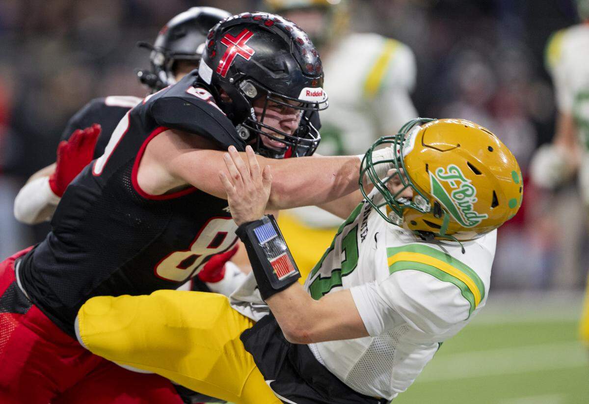 Archbishop Murphy defensive lineman Jack Sievers (85) hits Tumwater quarterback Jaxon Budd (17) as he throws during the fourth quarter of the 2A State Championship game at Husky Stadium, on Saturday, Dec. 6, 2025, in Seattle.
