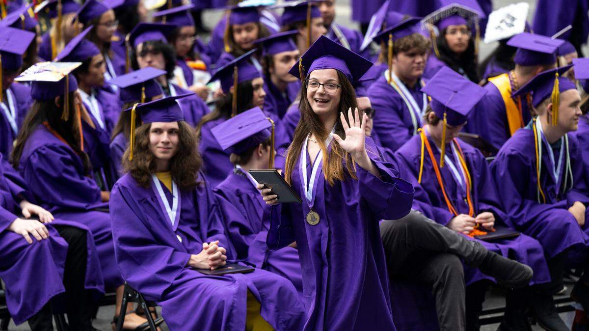 A Puyallup High School senior waves to the crowd after receiving her diploma in this 2022 file photo.