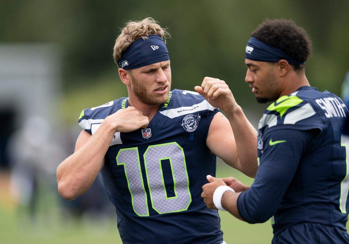 Seattle Seahawks tight end Elijah Arroyo (18) and wide receiver Jaxon Smith-Njigba (11) talk during training camp at Virginia Mason Athletic Center on Friday, July 25, 2025, in Renton, Wash.