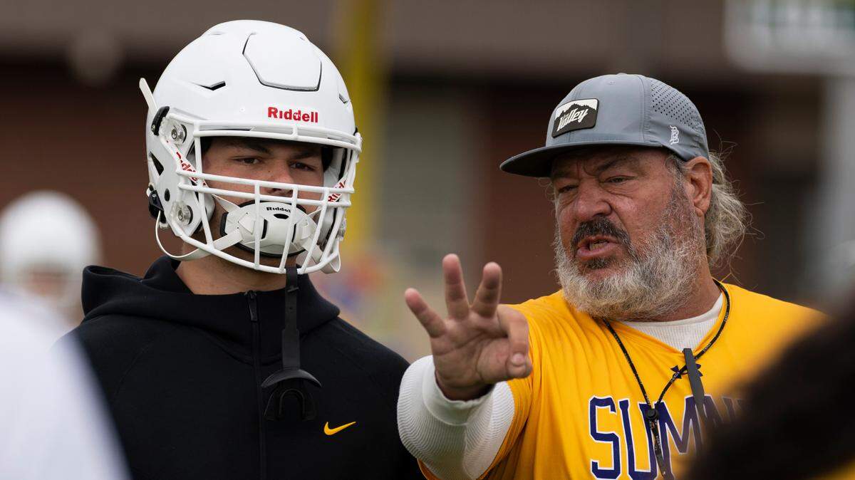 Sumner football coach Keith Ross coaches linebacker Austin Gilvar during a football practice at Sumner High School, on Thursday, Aug. 22, 2024, in Sumner, Wash.
