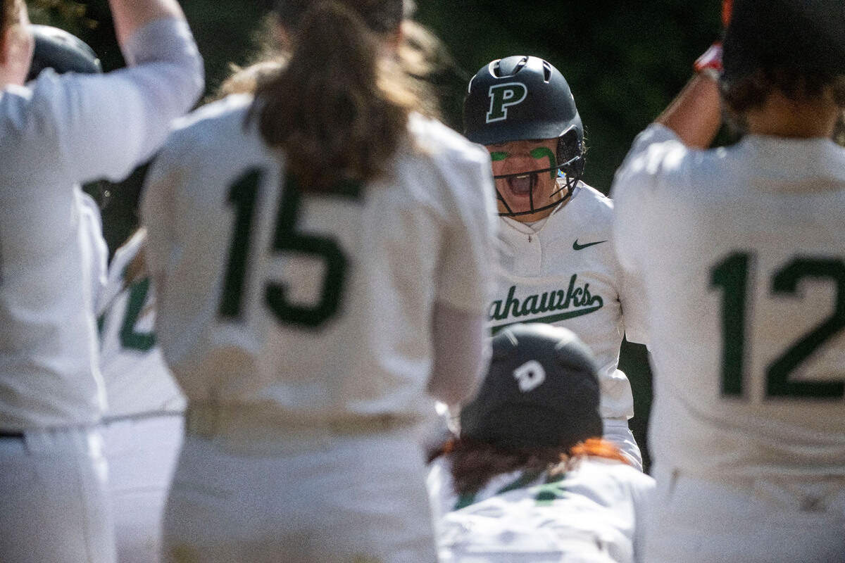 Peninsula’s Alli Kimball celebrates after hitting a home run in the bottom of the first inning of a 3A South Sound Conference game against Gig Harbor on Monday, April 17, 2023, at Peninsula High School in Gig Harbor, Wash.