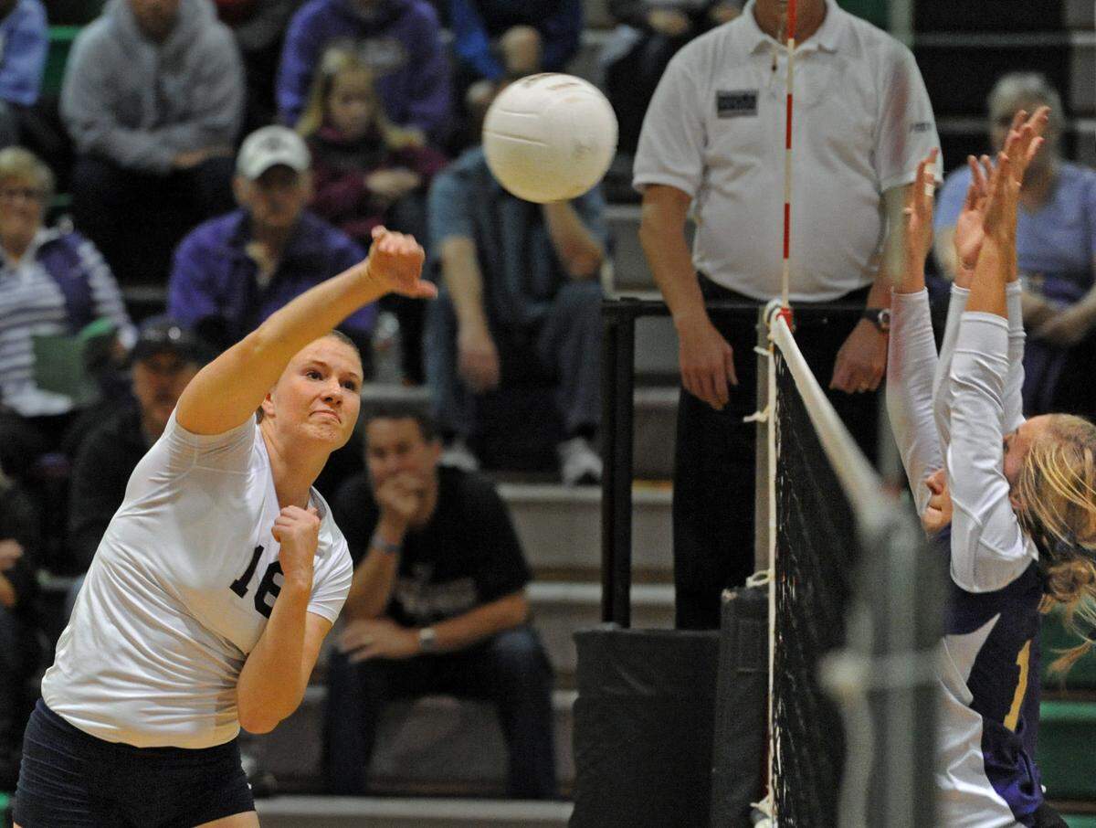 Courtney Schwan of Bellarmine pounds a spike in a volleyball match against Puyallup High School at Kentwood HS in the West Central District AAAA tournament. November 4, 2011 Peter Haley / Staff photographer