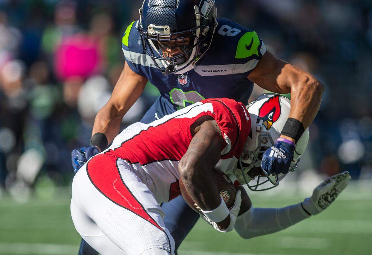 Seattle Seahawks cornerback Coby Bryant (8) tackles Arizona Cardinals wide receiver Marquise Brown (2) in the first quarter of an NFL game on Sunday, Oct. 16, 2022, at Lumen Field in Seattle.
