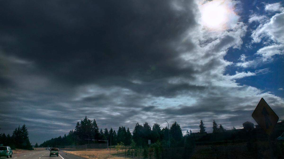 Dark clouds roll in to obscure the morning sunshine and blue skies over Lacey, Washington, on Wednesday, Sept. 15, 2021.