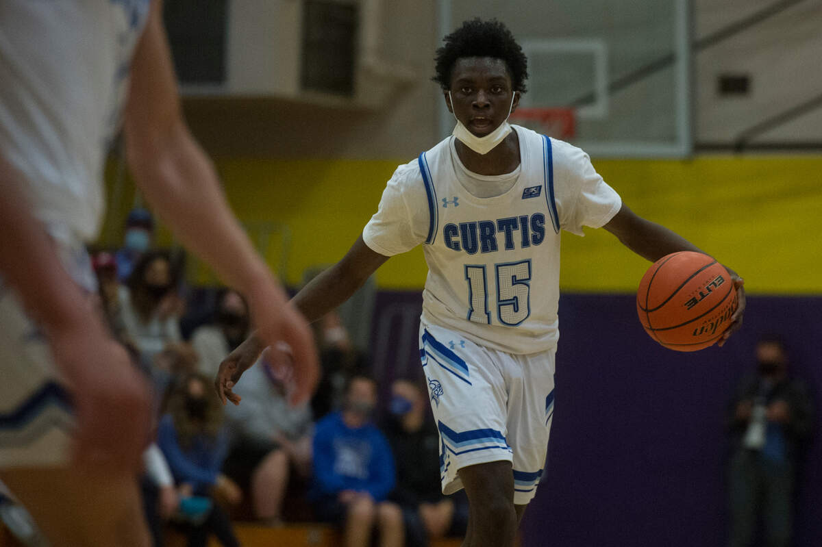 Curtis High School guard Zoom Diallo brings the ball up court during the 4A SPSL boys basketball championship game against Olympia on Thursday, June 10, 2021 at Puyallup High School in Puyallup, Wash.
